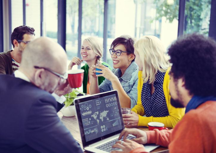 A diverse group of people sitting at a table and talking.