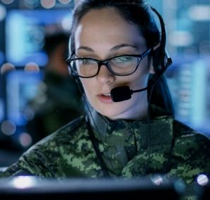 A woman wears a headset and gives instructions after learning what you can do with an emergency degree.