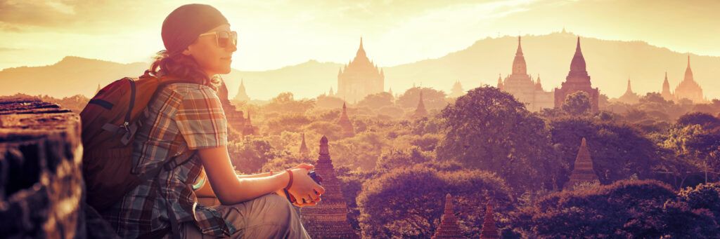 Female student on a gap year overlooking castles in Europe on a backpacking trip. 