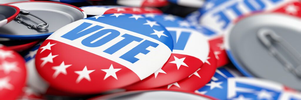 Red, white, and blue voting bages in a pile.