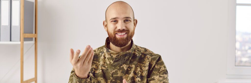 Student who is in the military smiling in military uniform.