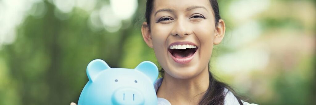 College student holding a blue piggy bank.