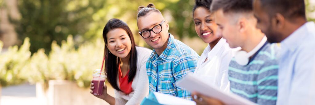 A group of sustainability students studying together outdoors.