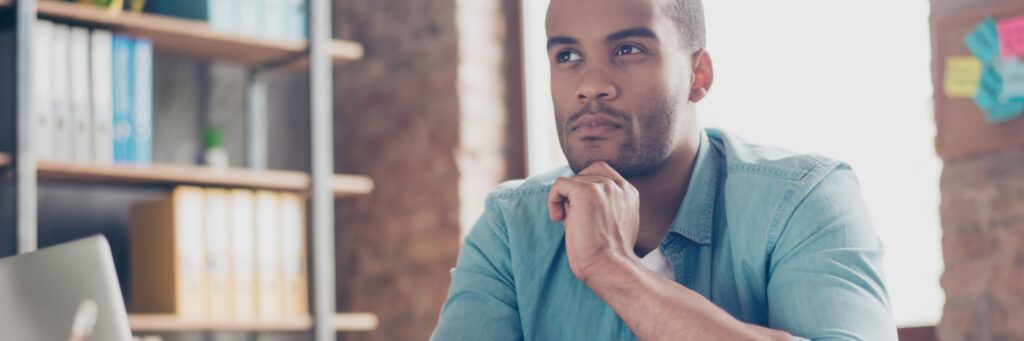 A man looks into the distance in thought while considering essential skills for public health students.